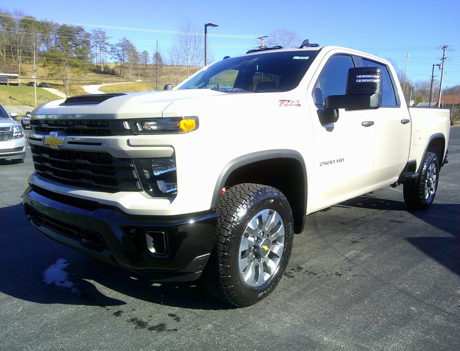 2026 Chevrolet Silverado 2500 HD Custom in White Sands — front three-quarter view