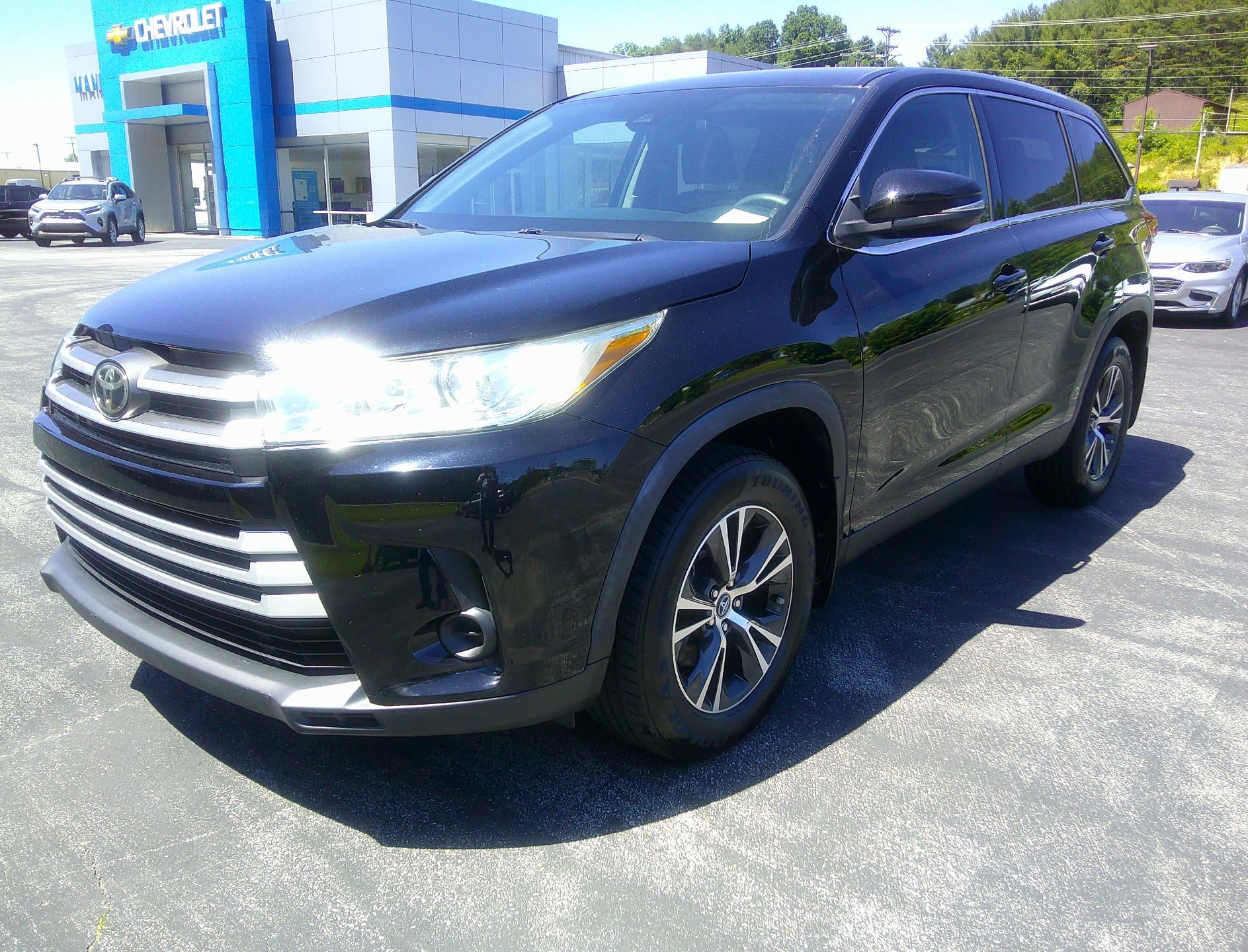 2019 Toyota Highlander LE in Black — front three-quarter view